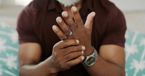 Man with arthritis rubbing his sore hands