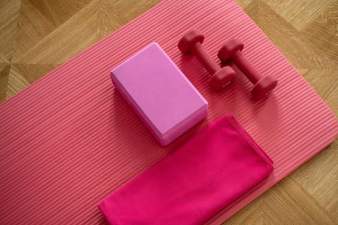Yoga mat with hand weights and fitness equipment
