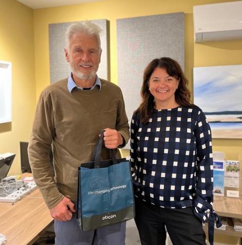 Dr. Erin Wright Awards Doug Bell His Premium Oticon Hearing Aids